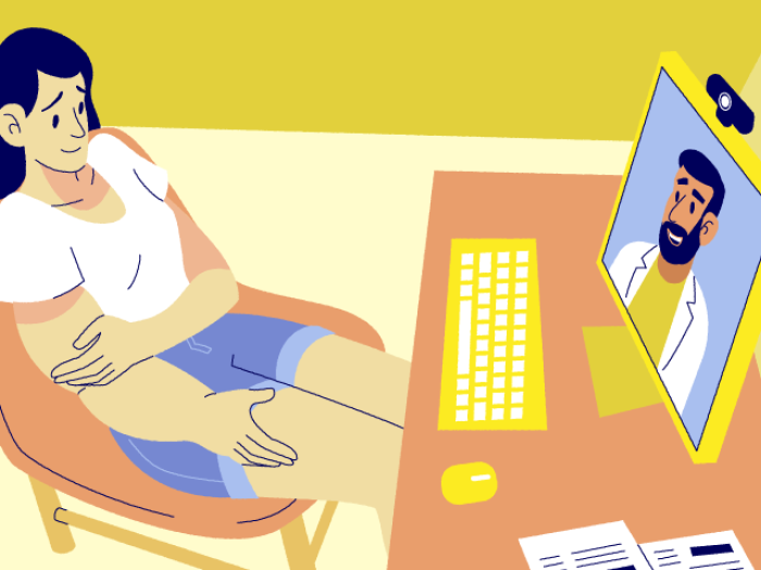 Woman sitting at desk with doctor on zoom