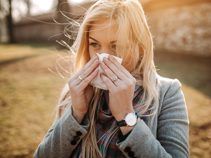 woman blowing her nose