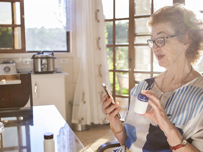 woman on phone call with prescription 