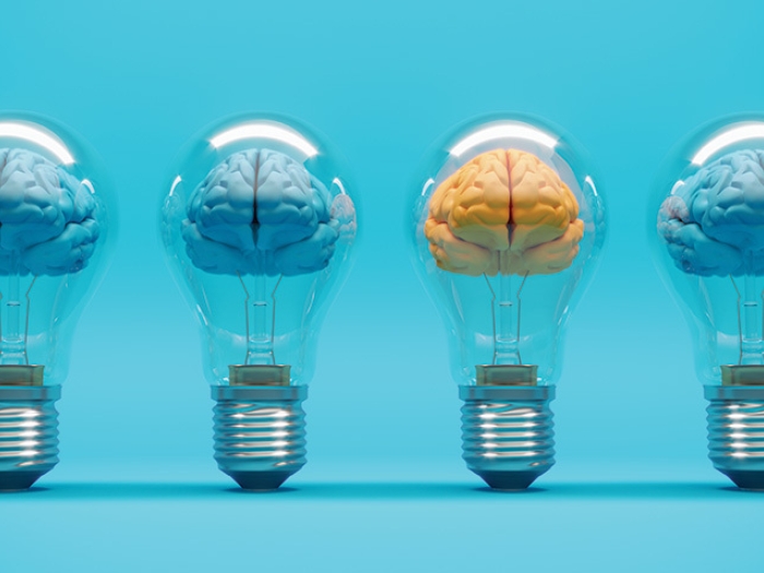 brains in blue in lightbulbs and one orange