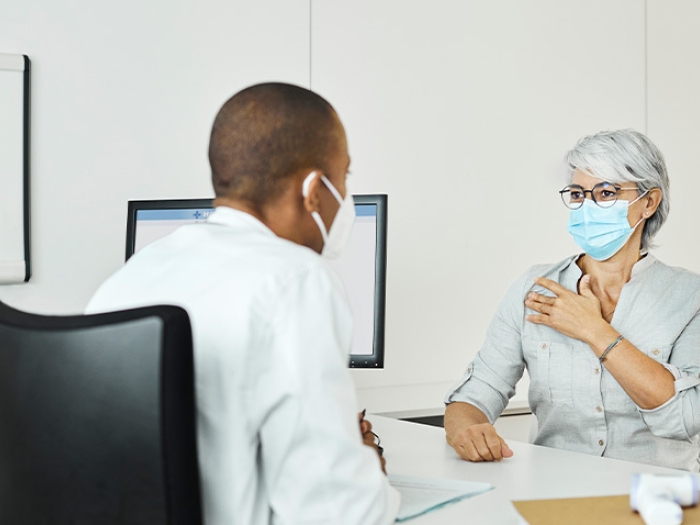 female patient discussing with doctor