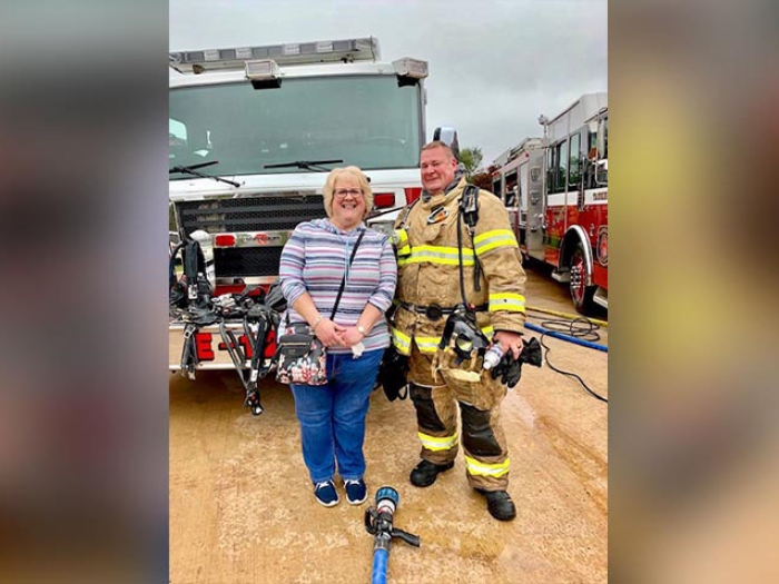 Firefighter in front of fire truck