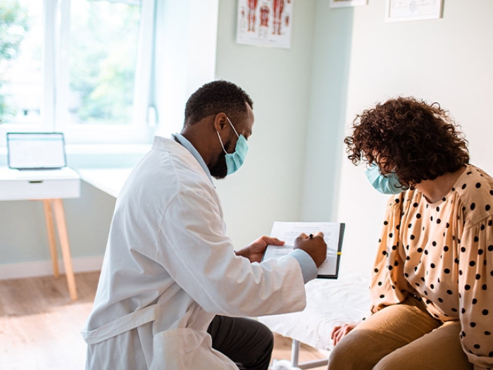 male doctor showing woman info