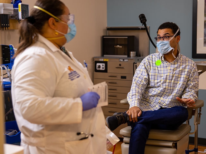 man talking with doctor in office