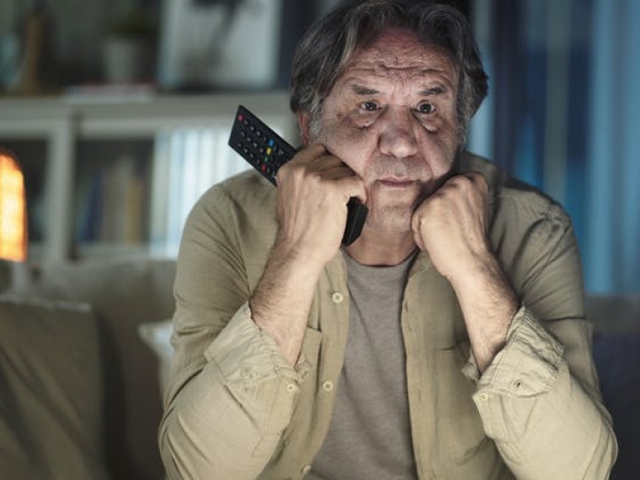 man worried with hands under chin
