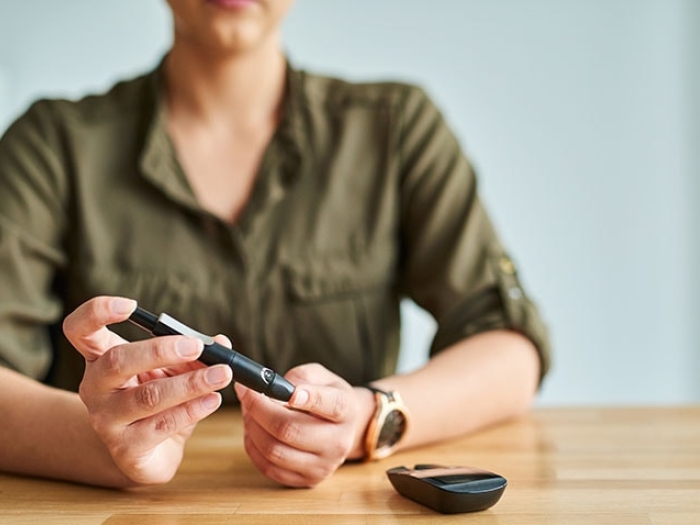 woman testing her blood sugar