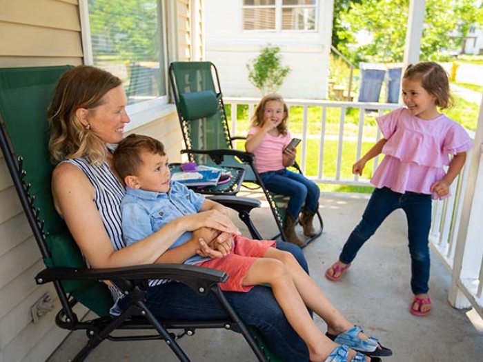 mom and children on front porch playing