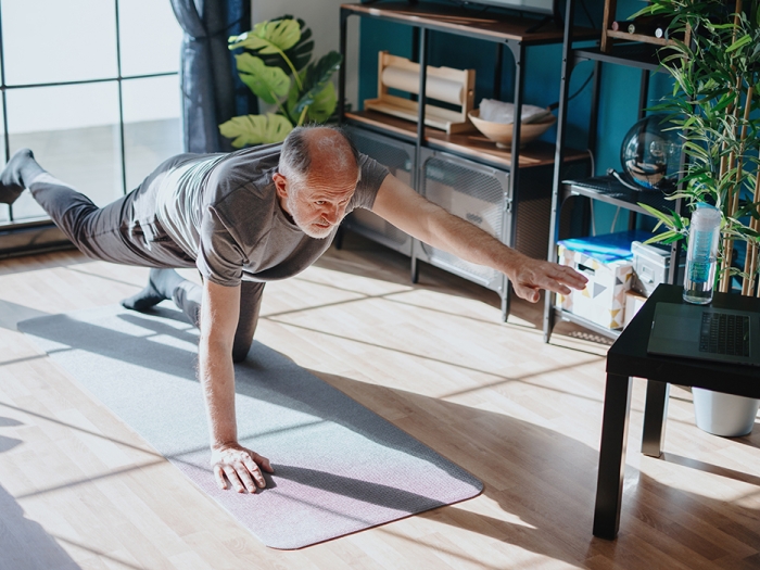 older man doing yoga low
