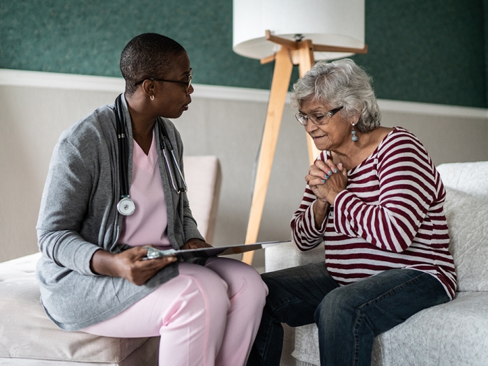 older woman speaking to care provider low