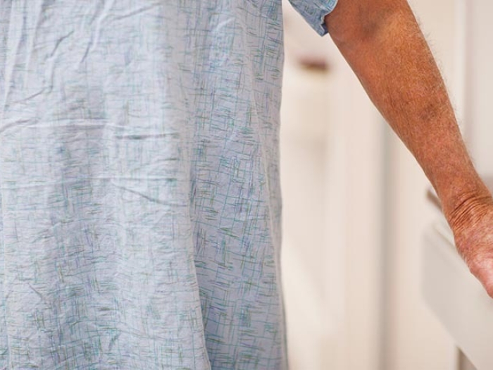 Patient holding onto rail in hospital