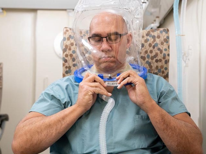 person with hyperbaric chamber mask on