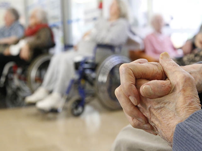 Senior hands folded in senior living