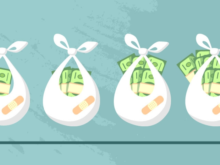 Four white bundles holding incrementally more money as move from left to right