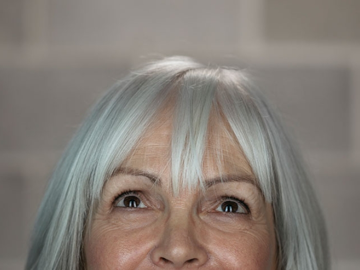 Woman with white hair looking up
