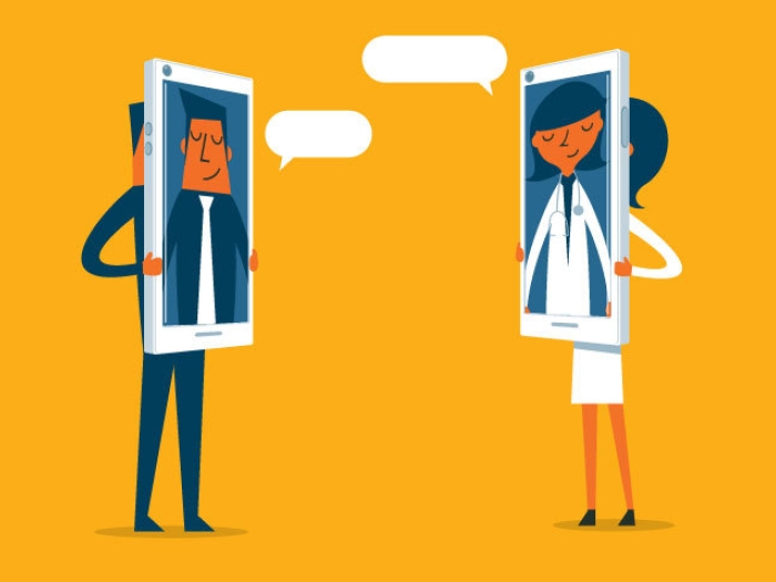 two people standing with phones over their faces with orange background