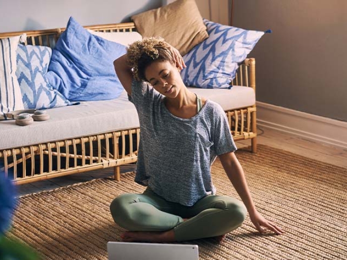 girl stretching neck while sitting