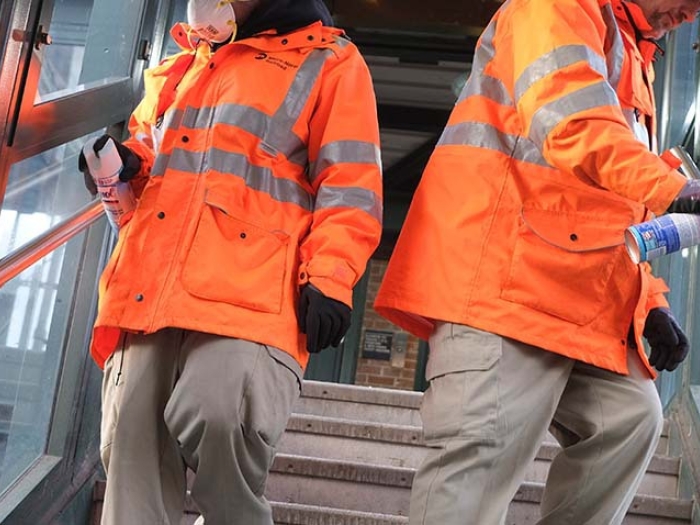 Workers spraying disinfectant on stairway