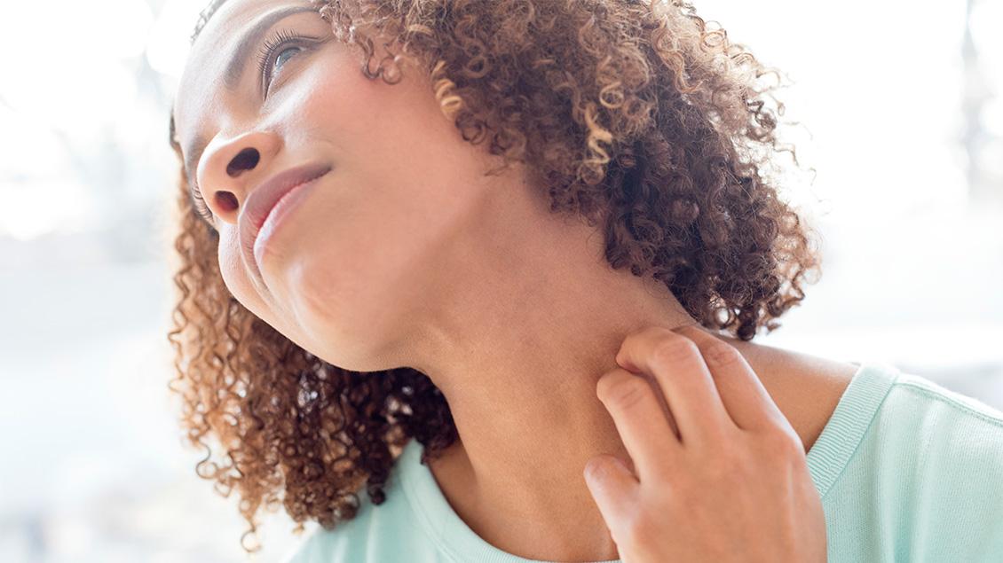Woman scratching neck