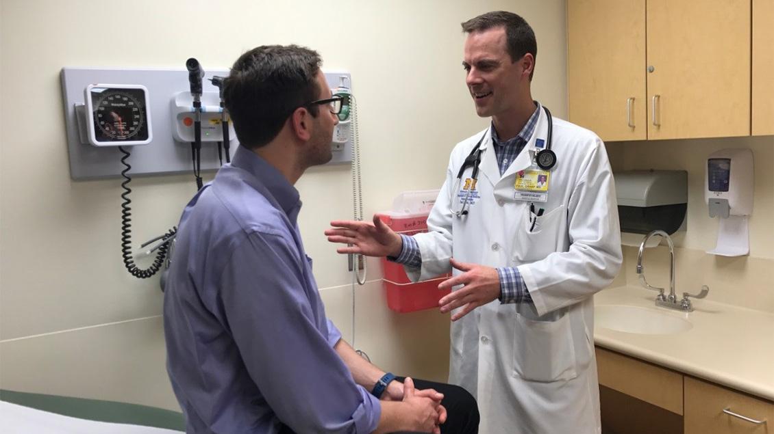 Doctor with patient in exam room