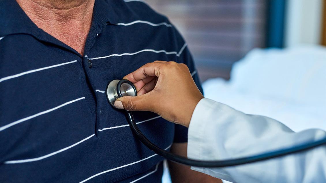 A doctor listening to a patient's heart