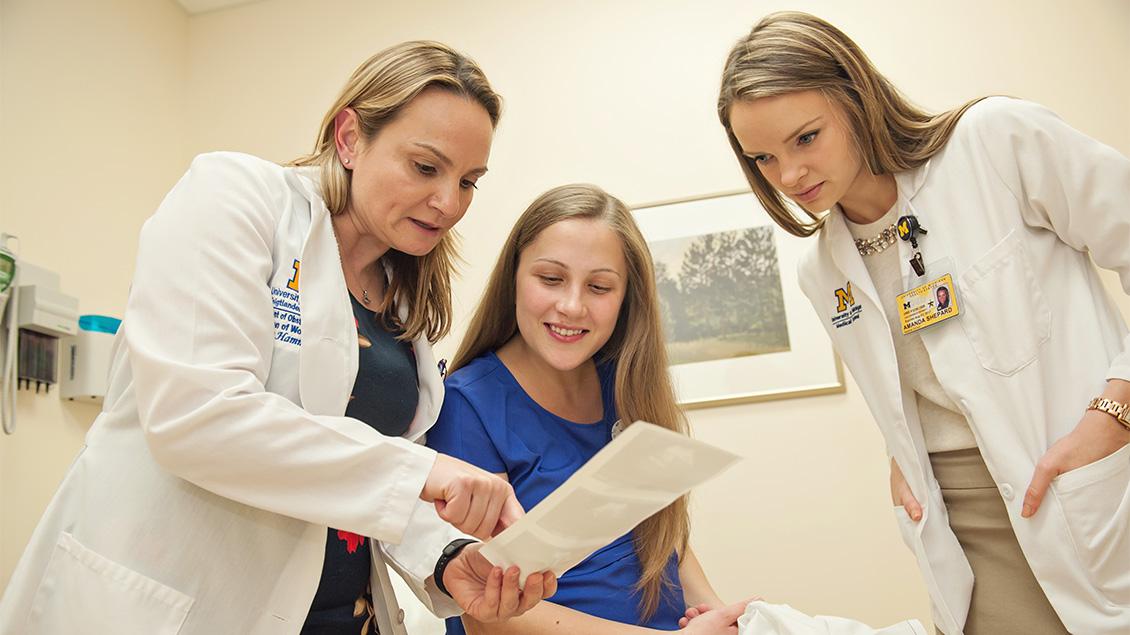 Doctor and medical student with patient