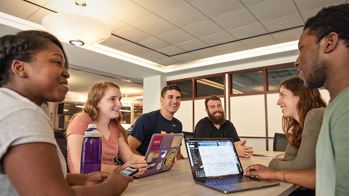 Students talking at a table