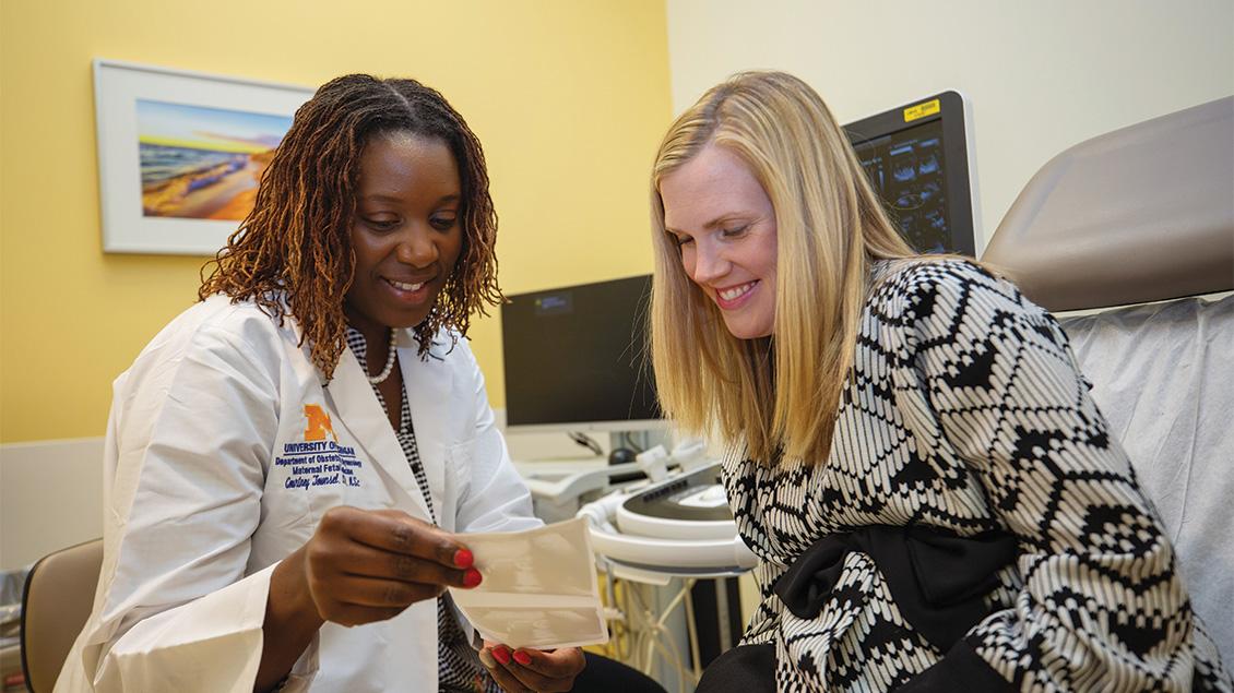 Doctor and patient reviewing ultrasound image