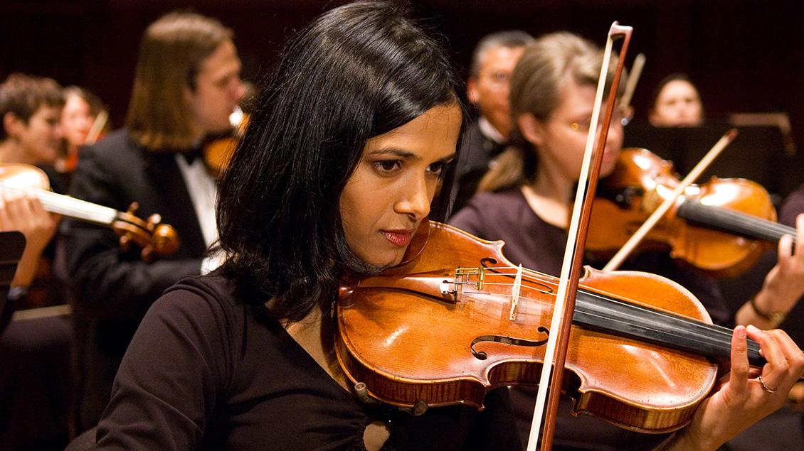 A violinist performs with the Life Sciences Orchestra