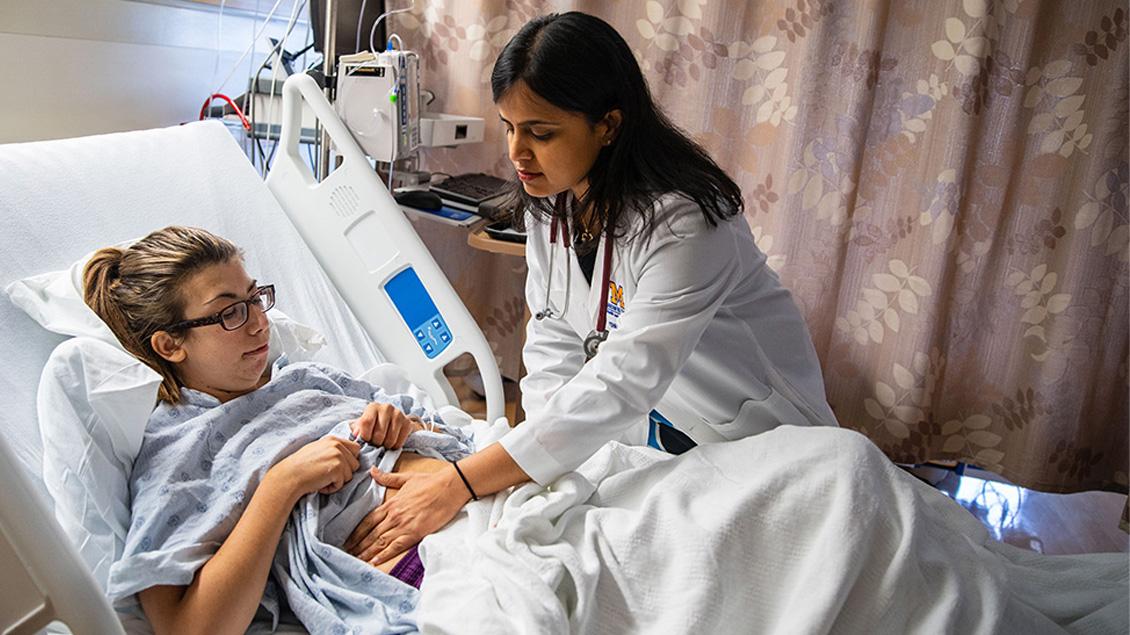 Doctor examining a patient's abdomen
