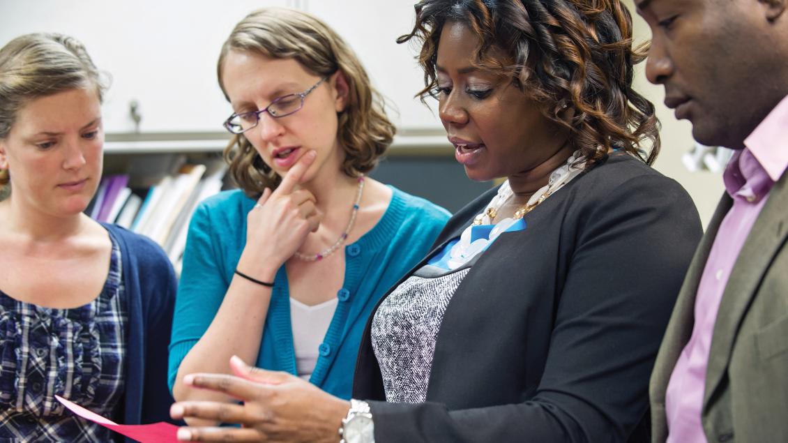 Polly Gipson and colleagues looking at a red piece of paper