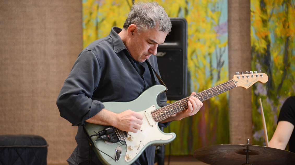 An electric guitar player performs as part of Gifts of Art