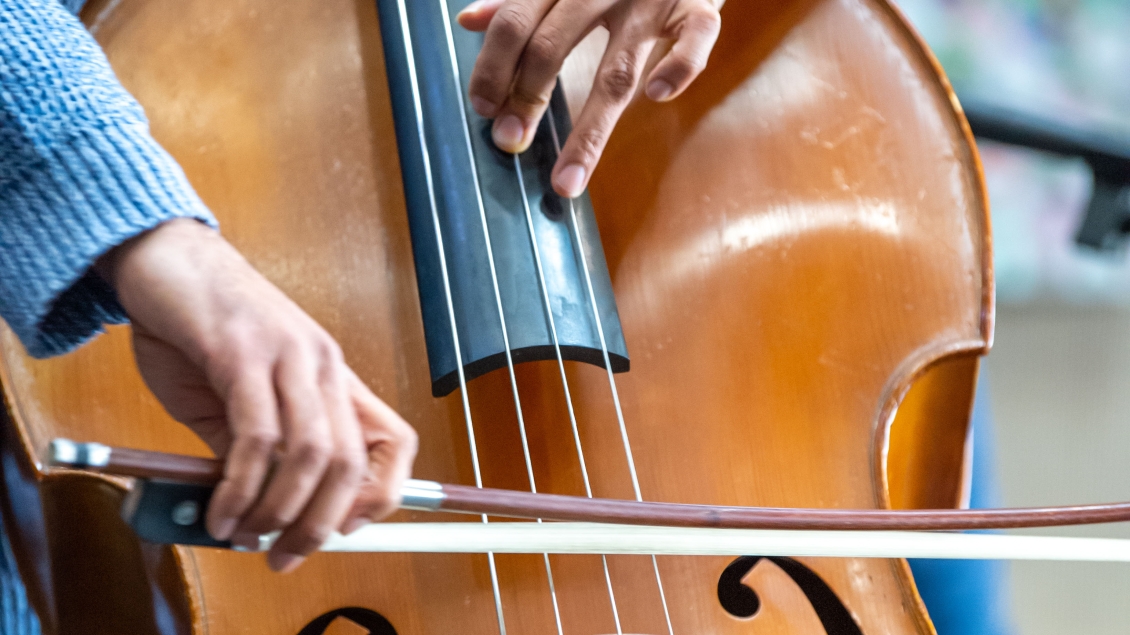 Close-up of upward bass player