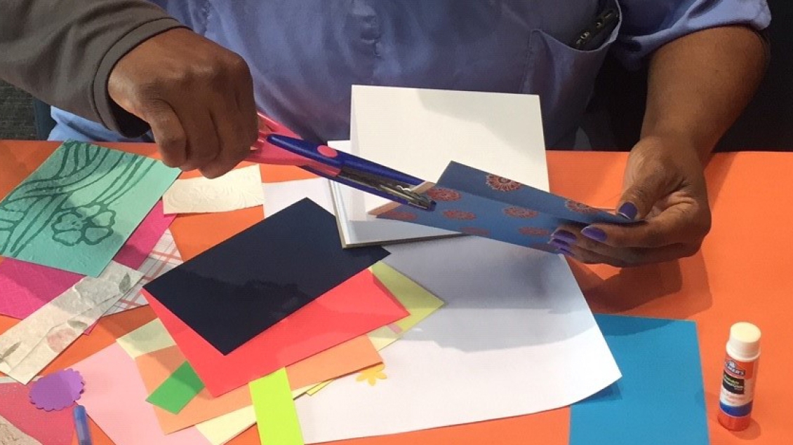 A volunteer works on paper crafts