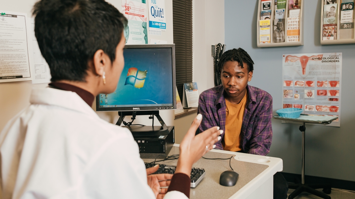 Dr. Nash speaks with a teen boy