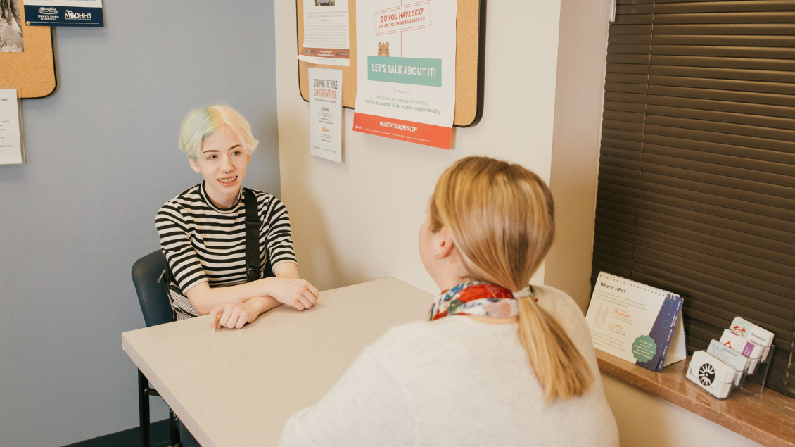 teen talks with clinician
