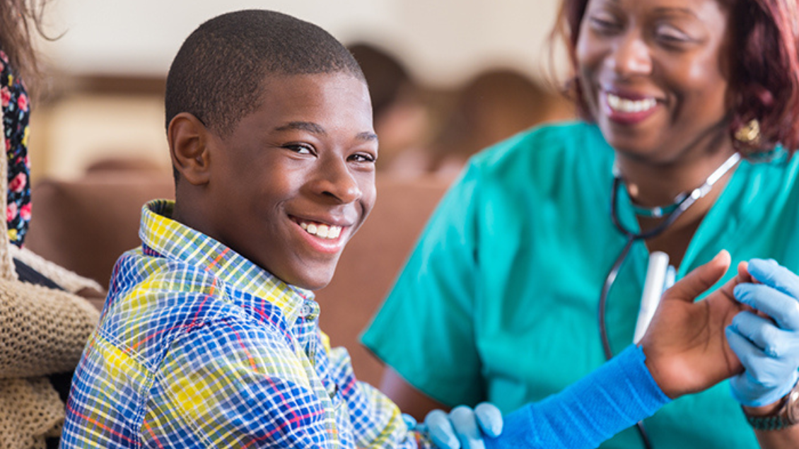 student smiles next to nurse