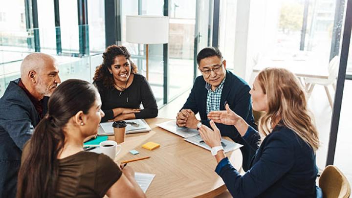Group of diverse office workers seated at table