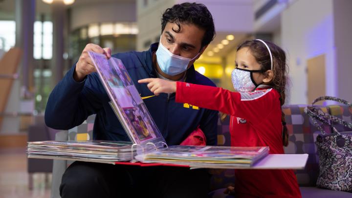 Man with child looking through photo album