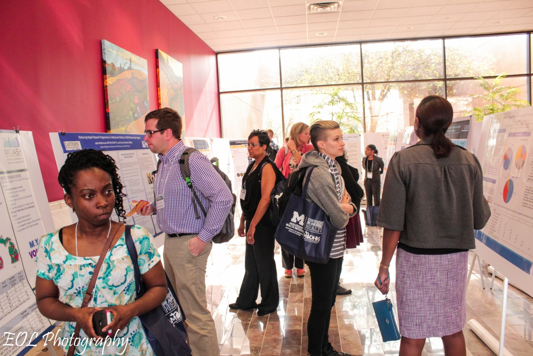 Group of people looking at various information boards.