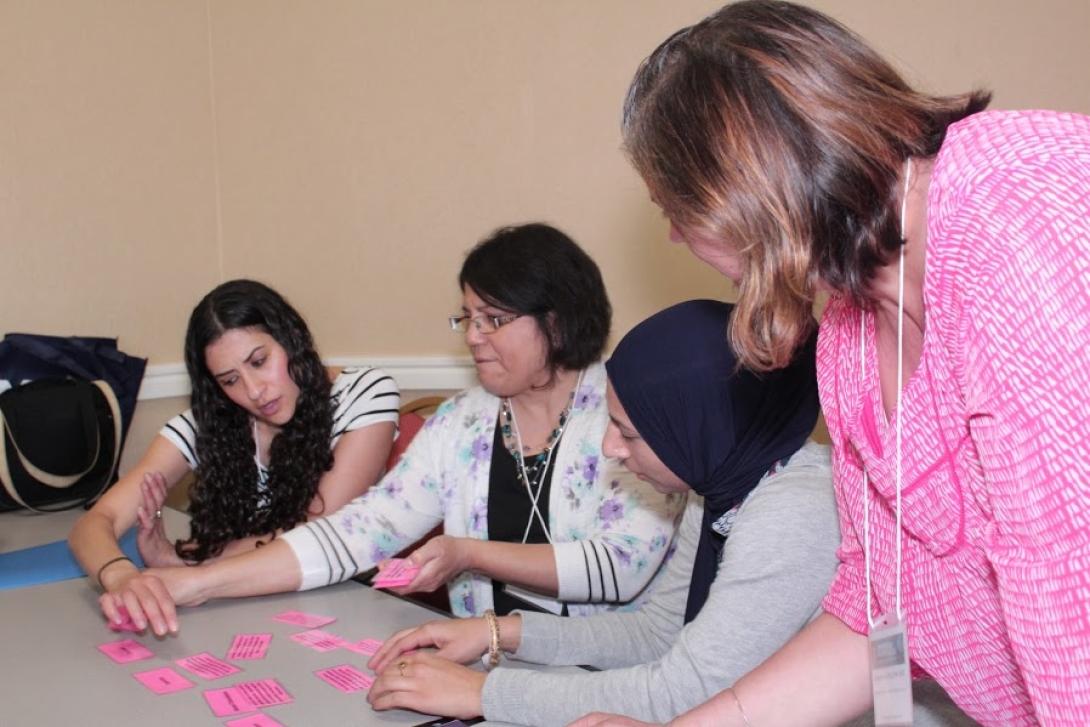 Group of people discussing and looking at sticky notes.